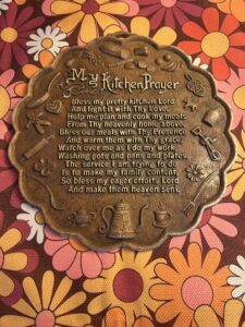 Vintage 1970s raised relief ‘My Kitchen Prayer’ faux-bronze wall plaque with embossed kitchen motifs.