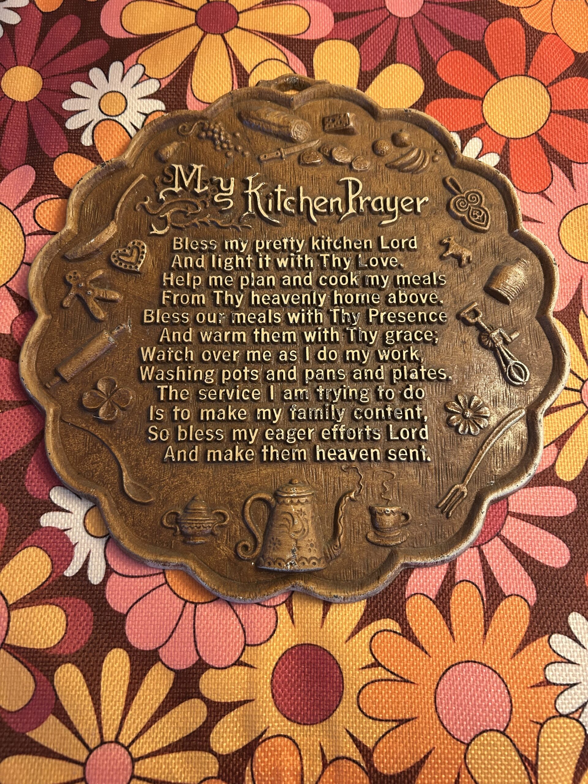 Vintage 1970s raised relief ‘My Kitchen Prayer’ faux-bronze wall plaque with embossed kitchen motifs.